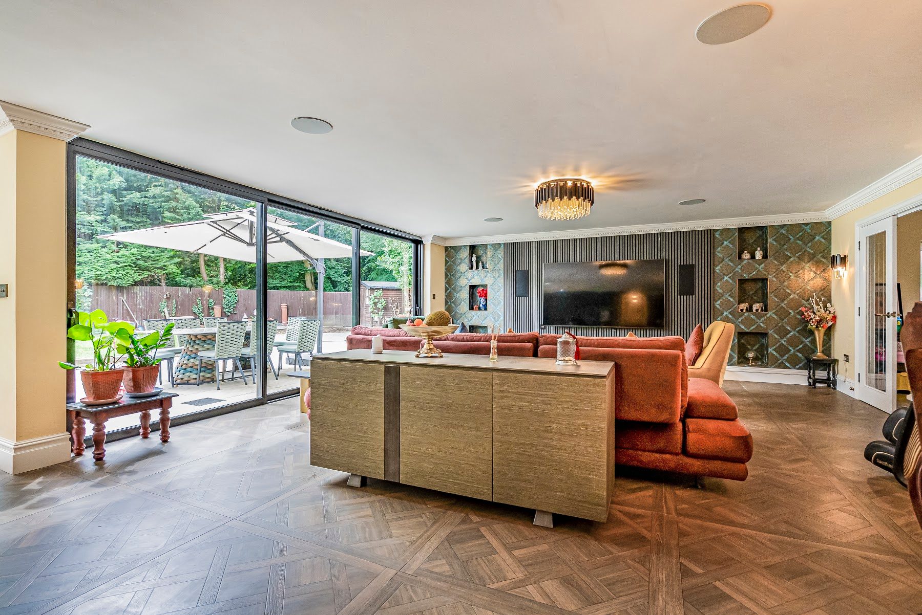 Open-plan living space with glazed sliding doors opening onto the garden