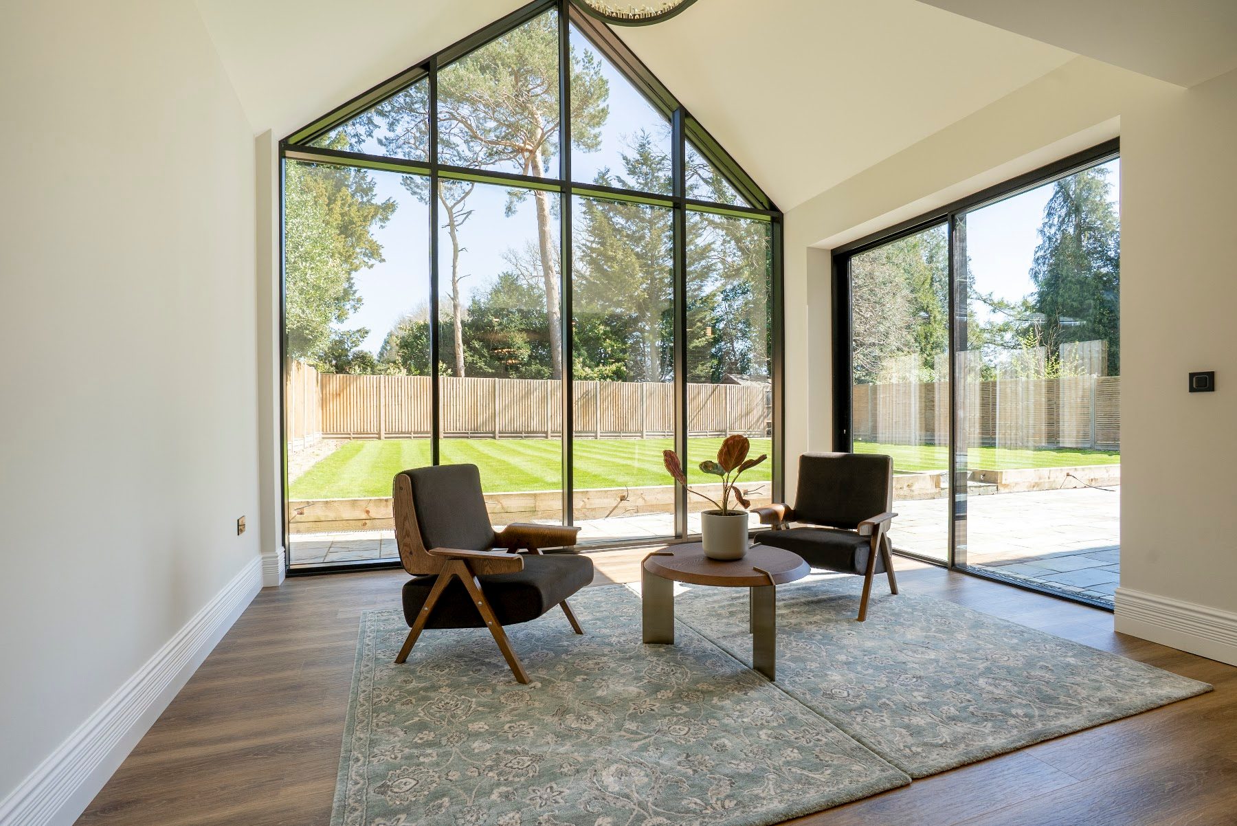 Double-height garden room with floor-to-ceiling glazing and a vaulted roof